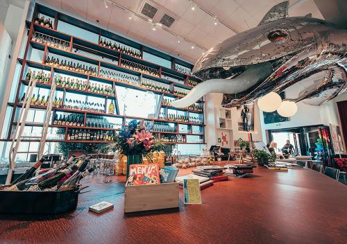 a restaurant with a shark hanging from the ceiling at Hotel AX in Helsinki