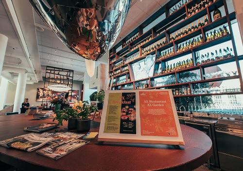 a bar with a menu on a table in a restaurant at Hotel AX in Helsinki