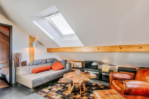 a living room with a couch and a table at Beautiful 3-rooms flat Terrace - Sun - Calm in Annecy-le-Vieux