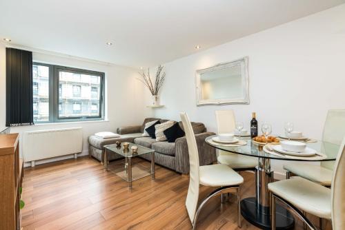 a living room with a couch and a table at Direct Tube Links to Central London , Walk to Station one bedroom flat in Greater London, ID required in London