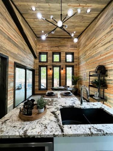 a kitchen with a marble counter top and a sink at Soho Loft in Broken Bow