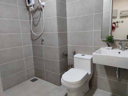 a bathroom with a toilet and a sink at DS13 Dsara 50inch 4k tv Netflix mrt next SB Hospital in Sungai Buluh