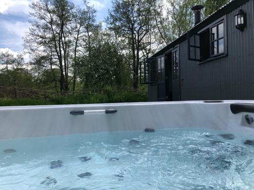 a hot tub in the backyard of a house at Large Luxury Shepherds Hut with Hot Tub nr Bath in Bristol