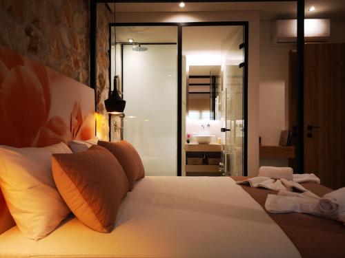 a bedroom with a bed and a bathroom with a shower at Estilo luxury apartment in Kavala