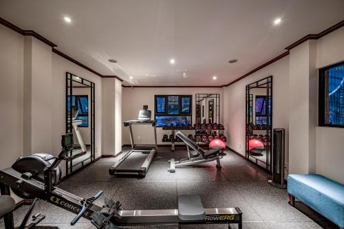 a gym with several treadmills and machines in a room at Amanaki Saigon Boutique Hotel in Ho Chi Minh City