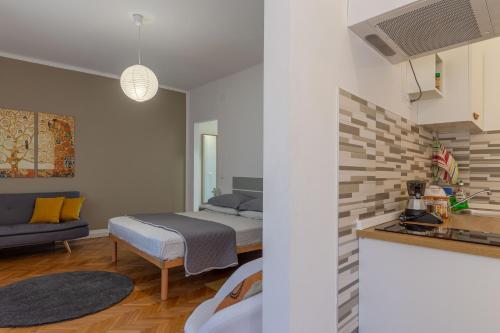 a bedroom with a bed and a living room at CasamargheRita in Muggia