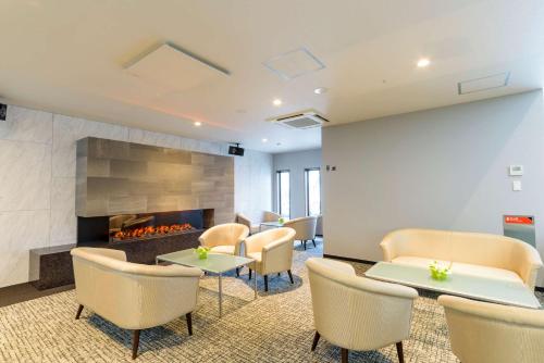 a waiting room with chairs and a fireplace at Best Western Plus Hotel Fino Chitose in Chitose