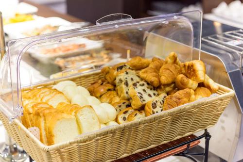 a basket of different types of bread and pastries at Best Western Plus Hotel Fino Chitose in Chitose