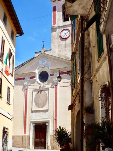 a church with a clock tower on top of it at Casa Celestine in Via Orsini Isolabona Liguria Italy Sleeps 5 in Isolabona