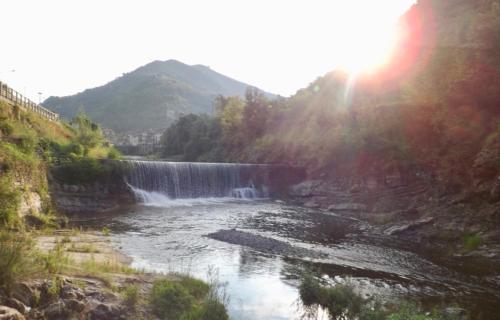 a waterfall on a river with the sun in the background at Casa Celestine in Via Orsini Isolabona Liguria Italy Sleeps 5 in Isolabona