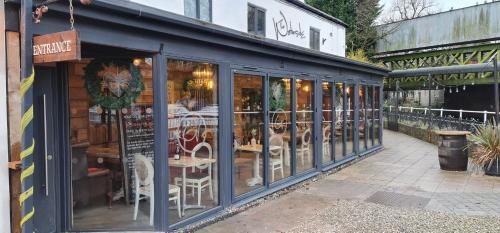 a restaurant with tables and chairs inside of a building at The Waterside Bar, Rooms & Restaurant in Manchester