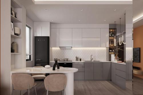 a kitchen with white cabinets and a table and chairs at Cat Ba Seoul 2 Hotel & Apartment in Cat Ba