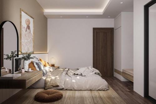 a bedroom with a bed and a table and a mirror at Cat Ba Seoul 2 Hotel & Apartment in Cat Ba