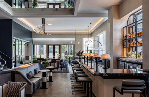 a bar in a restaurant with couches and tables at Thompson Savannah, by Hyatt in Savannah