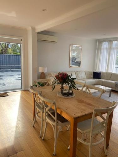 a living room with a wooden table and chairs at Large Kingston Beach Home Setup For Comfort in Kingston Beach