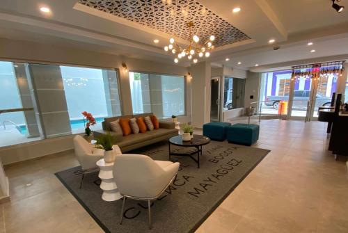 a living room with a couch and chairs at TRYP by Wyndham Mayaguez in Mayaguez