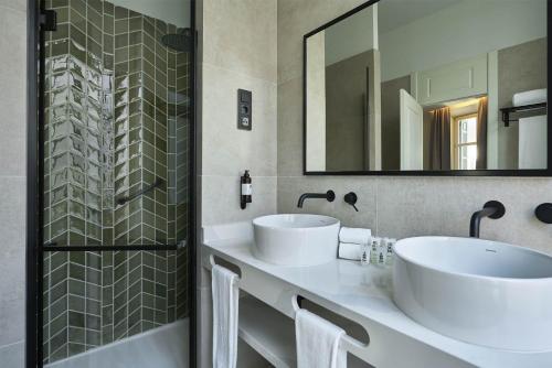 a bathroom with two sinks and a shower at Vincci Larios Diez in Málaga