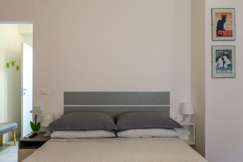 a bedroom with a large bed with a large headboard at CasamargheRita in Muggia