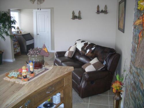 a living room with a leather couch and a table at Laramie Valley Inn in Laramie