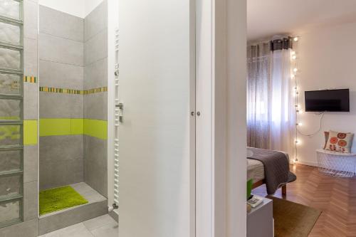 a bathroom with a walk in shower next to a bedroom at CasamargheRita in Muggia