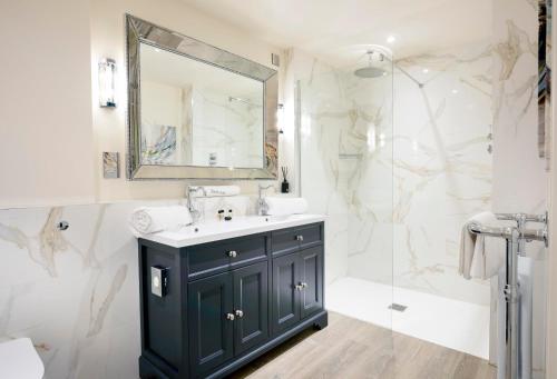 a bathroom with a sink and a shower at Manor House Hotel in Bishop Auckland