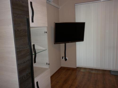 a room with a tv on the wall and a door at Luxury Villa Heviz in Hévíz