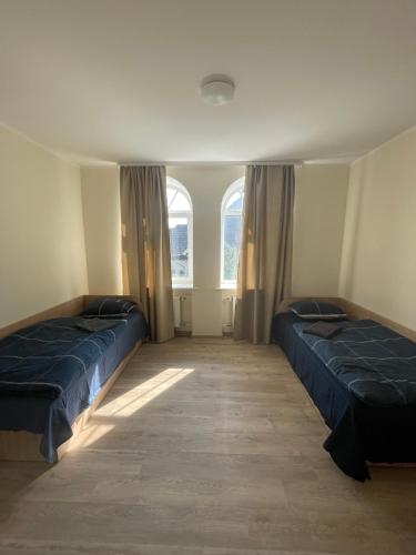 Una cama o camas en una habitación de Baltcity