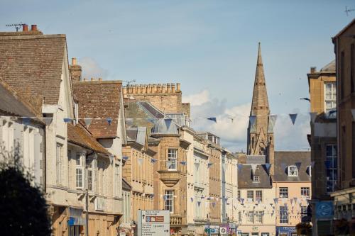 a city street with buildings and a church at Ednam House Hotel in Kelso