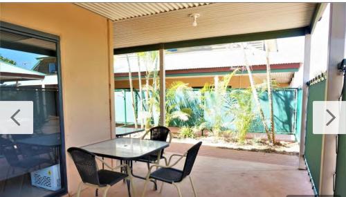 a patio with a table and chairs on a balcony at The Ningaloo breeze villa 6 in Exmouth