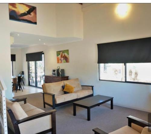 a living room with a couch and a table at The Ningaloo breeze villa 6 in Exmouth