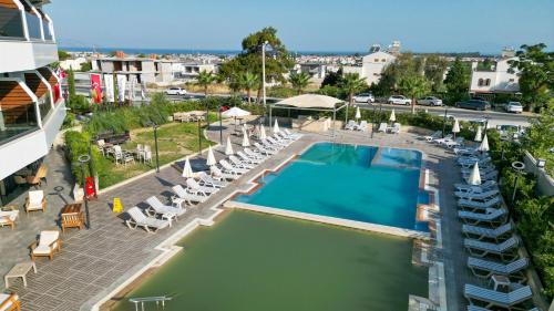 an overhead view of a swimming pool with lounge chairs and a building at Seven For Life Thermal Hotel in Kusadası