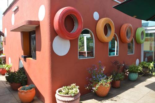 a red building with a sign that says ooops at Khweza Bed and Breakfast in Nairobi