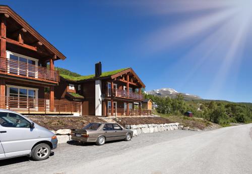 two cars parked in front of a house at Lastølen 2 bedrooms in Sykkylven