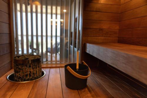a room with a sauna with a window and a wooden floor at Marina Resort A5 in Kalajoki