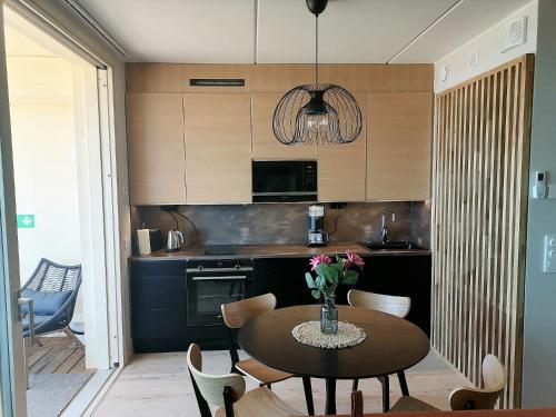 a kitchen with a table with chairs and a dining room at Marina Resort A5 in Kalajoki