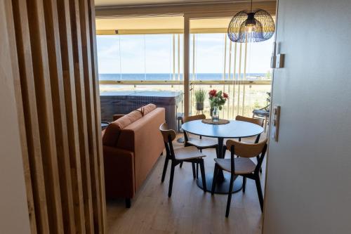 a living room with a table and a couch at Marina Resort A5 in Kalajoki