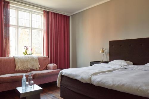 Una cama o camas en una habitación de First Hotel Grand