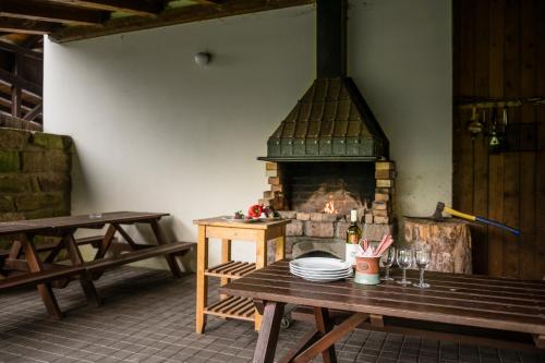 a room with a wooden table with a fireplace at Pension Herman in Rudník