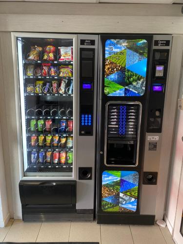 a vending machine filled with drinks and soda at Premiere Classe Beauvais in Beauvais
