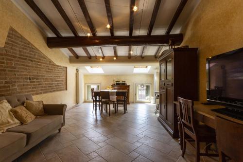 a living room with a couch and a tv and a table at Grace apartment - Smart Holiday in Mantova