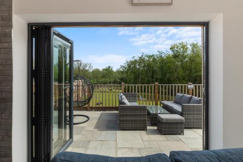 a view of a patio from a sliding glass door at Willow Cottage in Tenby