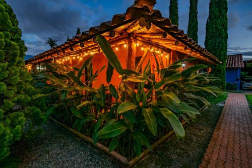 a house with lights on the side of it at Hotel Campestre Solar De La Luna in Armenia