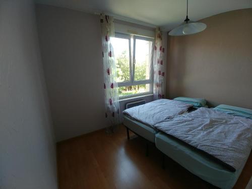 a small bedroom with a bed and a window at Park Line garden in Strasbourg