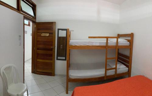 a room with two bunk beds and a door at Villa Nevada Hostel in Bananeiras