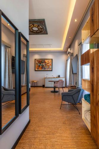 a living room with a couch and a table at Vila Origens Boutique Hotel Albufeira – Adults Only in Albufeira