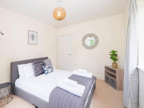 a bedroom with a bed and a dresser in it at Glas Mordros in St Ives