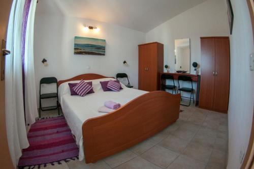 a bedroom with a bed and a table and chairs at House /Villa Maja in Ližnjan