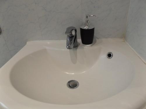 a white sink with a faucet on top of it at Gainford House in Walsgrave on Sowe