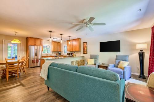 a living room with a blue couch and a kitchen at Nature's Edge in Asheville