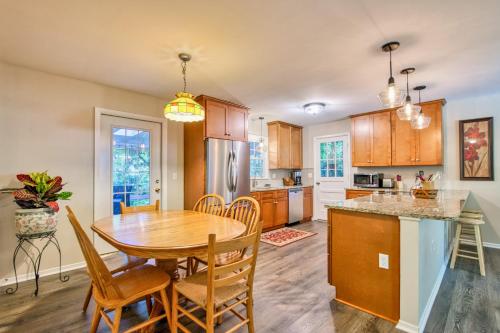 a kitchen and dining room with a wooden table and chairs at Nature's Edge in Asheville
